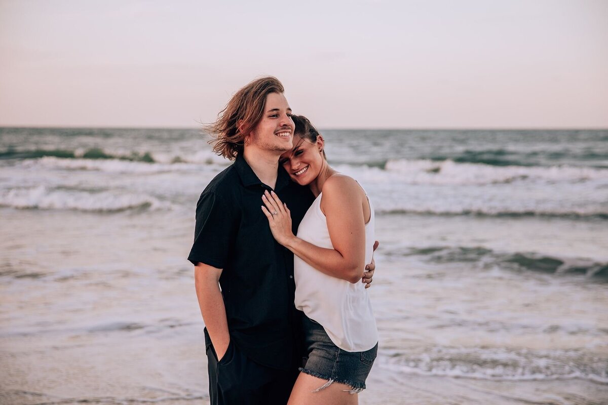 bride rests head on fiance's shoulder for engagement photo