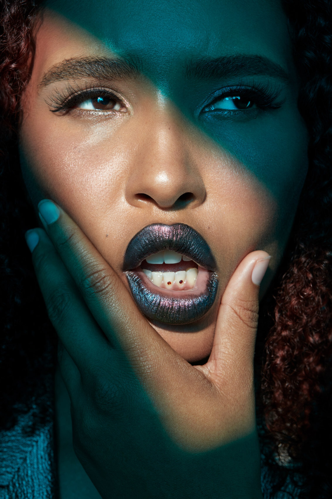 Jazz Walters in an intense, high-contrast portrait with striking makeup and vibrant colors, captured by Ylva Erevall.