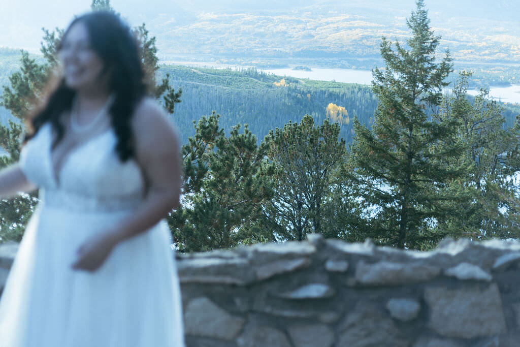 A person in a wedding dress walking along a mountain.