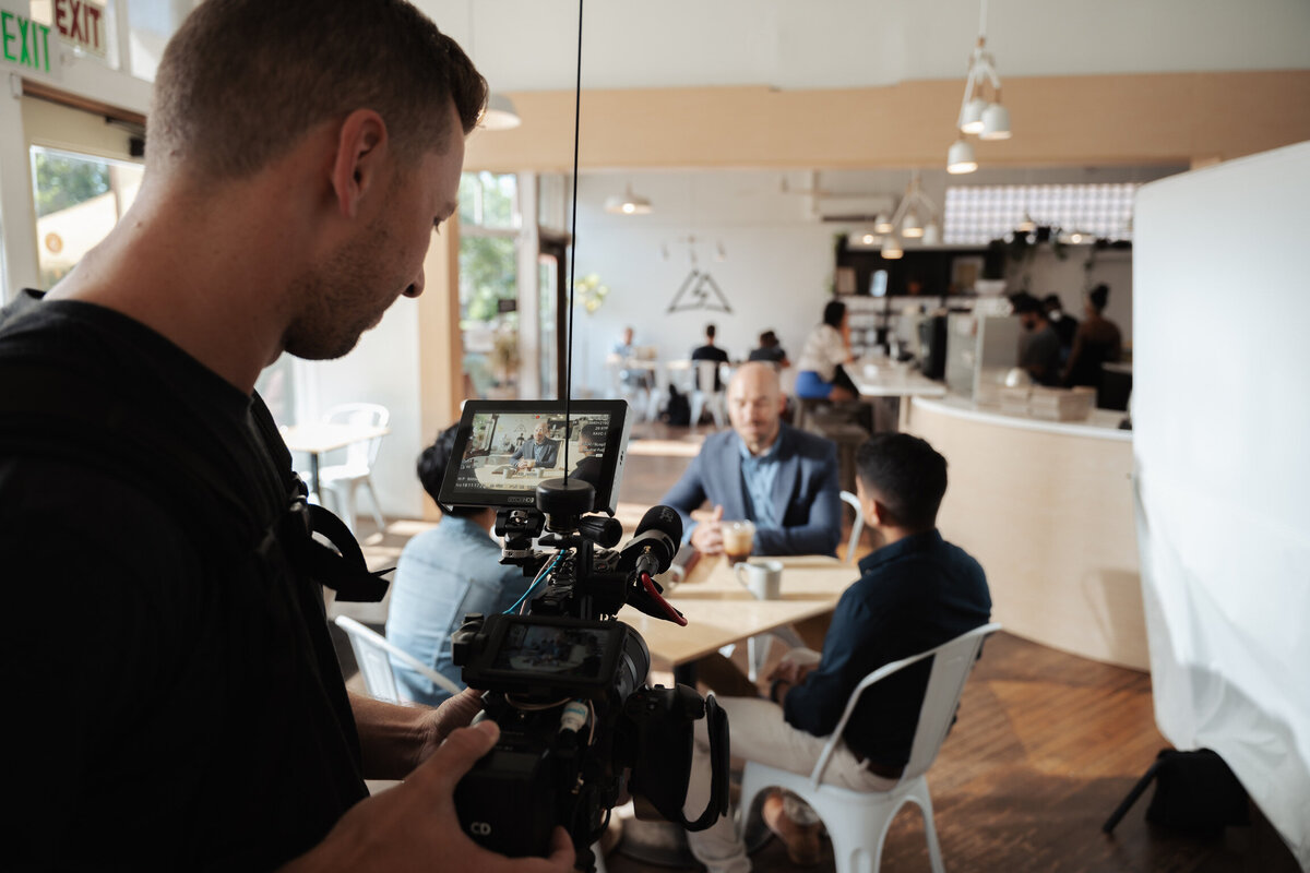 A candid shot of a videographer adjusting equipment on set, focused on capturing a dynamic scene. This image reflects the energy and attention to detail that Future Fox Media brings to promo video production in Denver, Colorado.