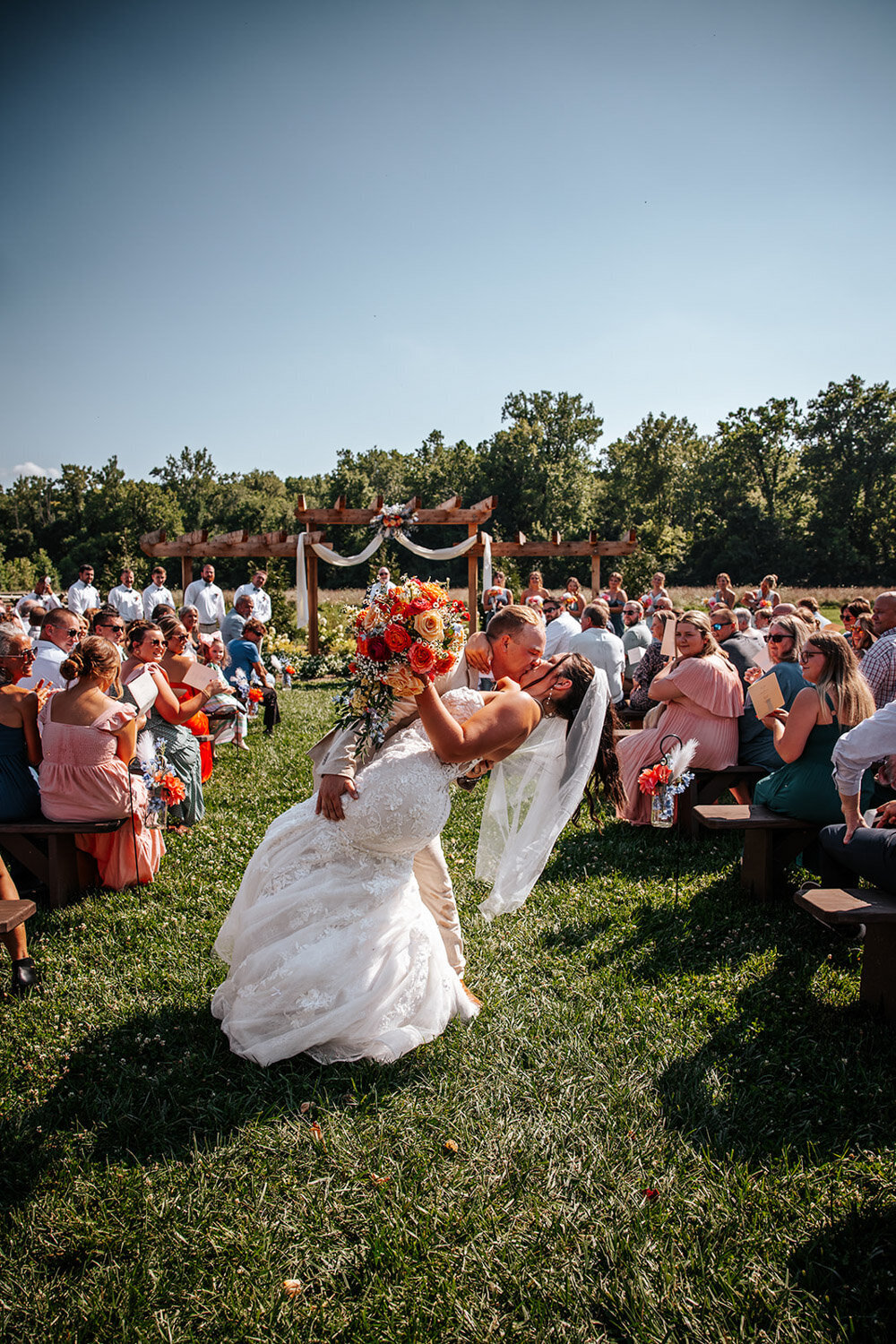 Married couples deep kiss after their wedding ceremony