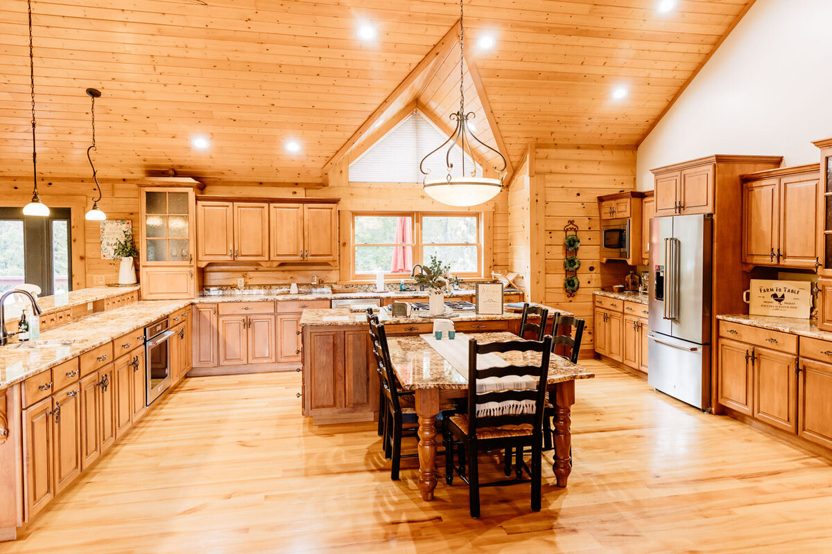 Expansive kitchen area with warm wood tones and natural lighting