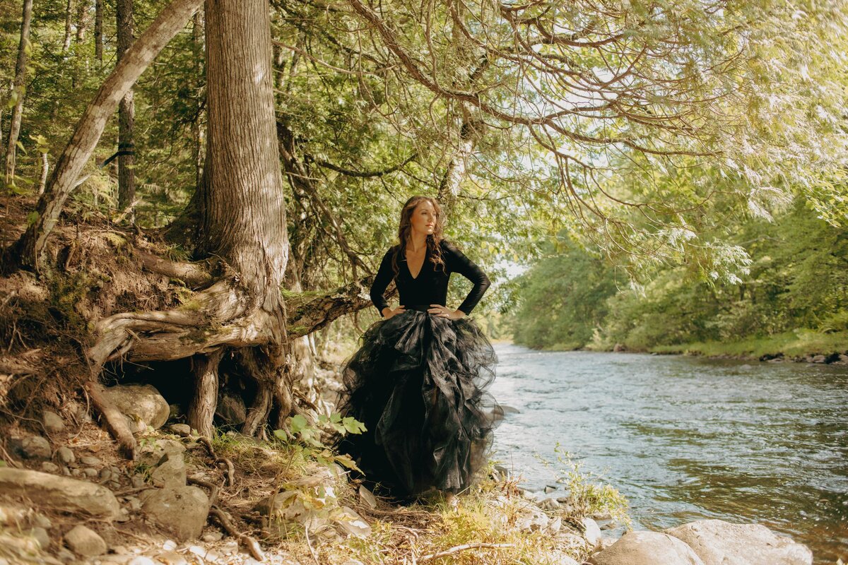 elizabeth in black dress by creek