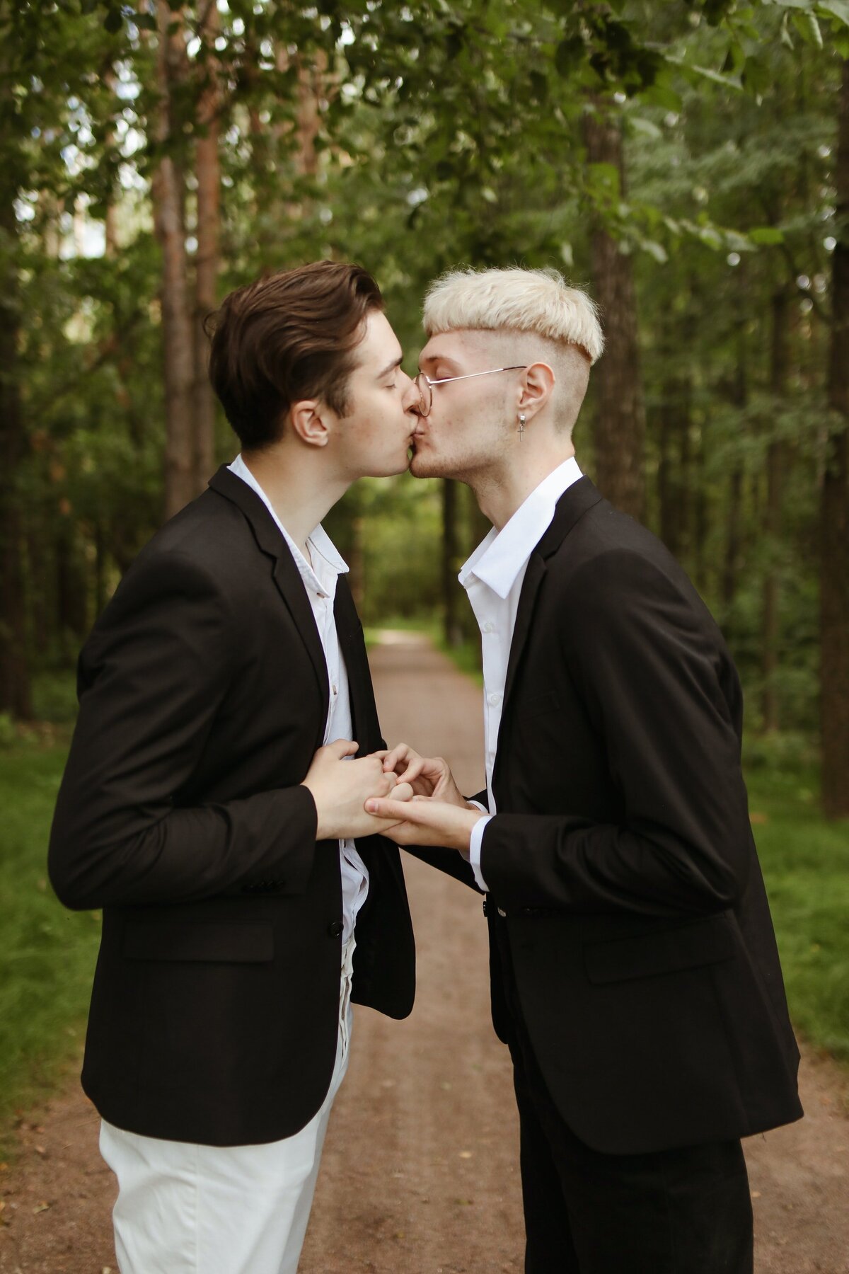 Groom kisses Groom on wedding day