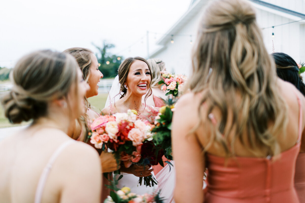 Bride is filled with joy surrounded by her bridesmaids after saying their ido's  at the ceremony