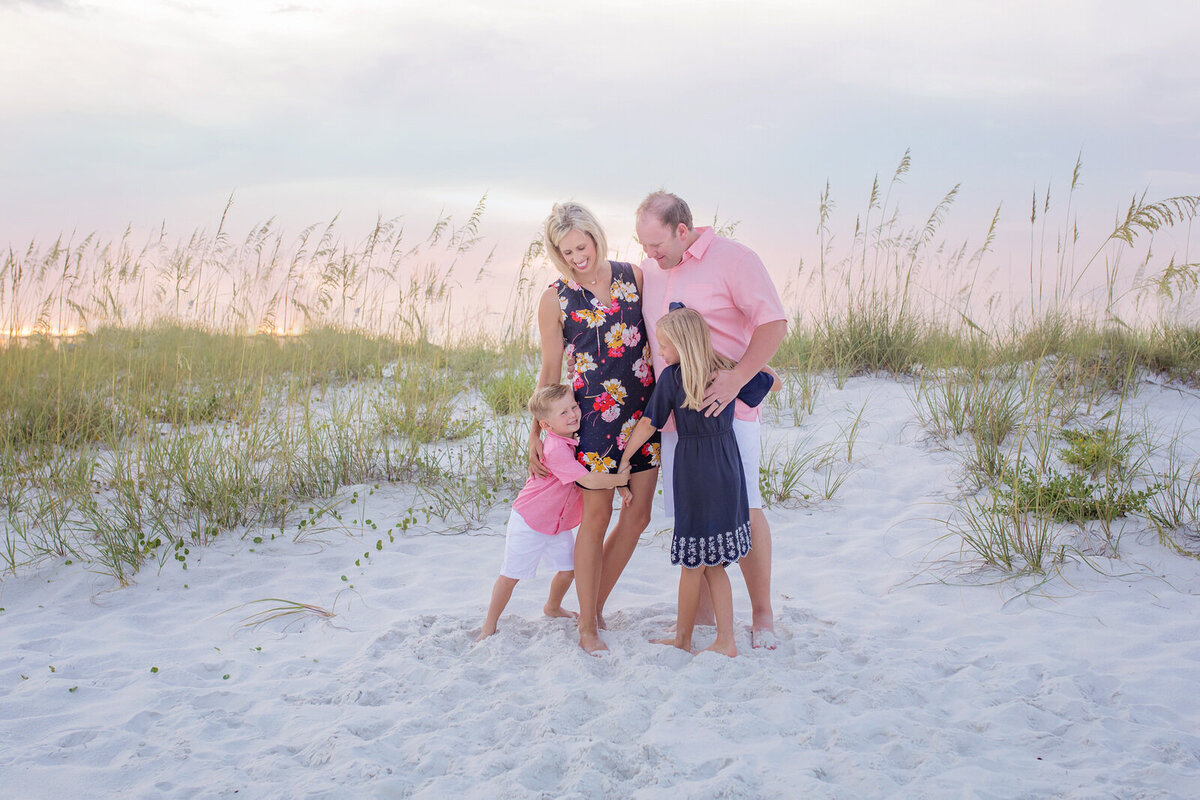 family-hugging-by-dunes-on-navarre-beach