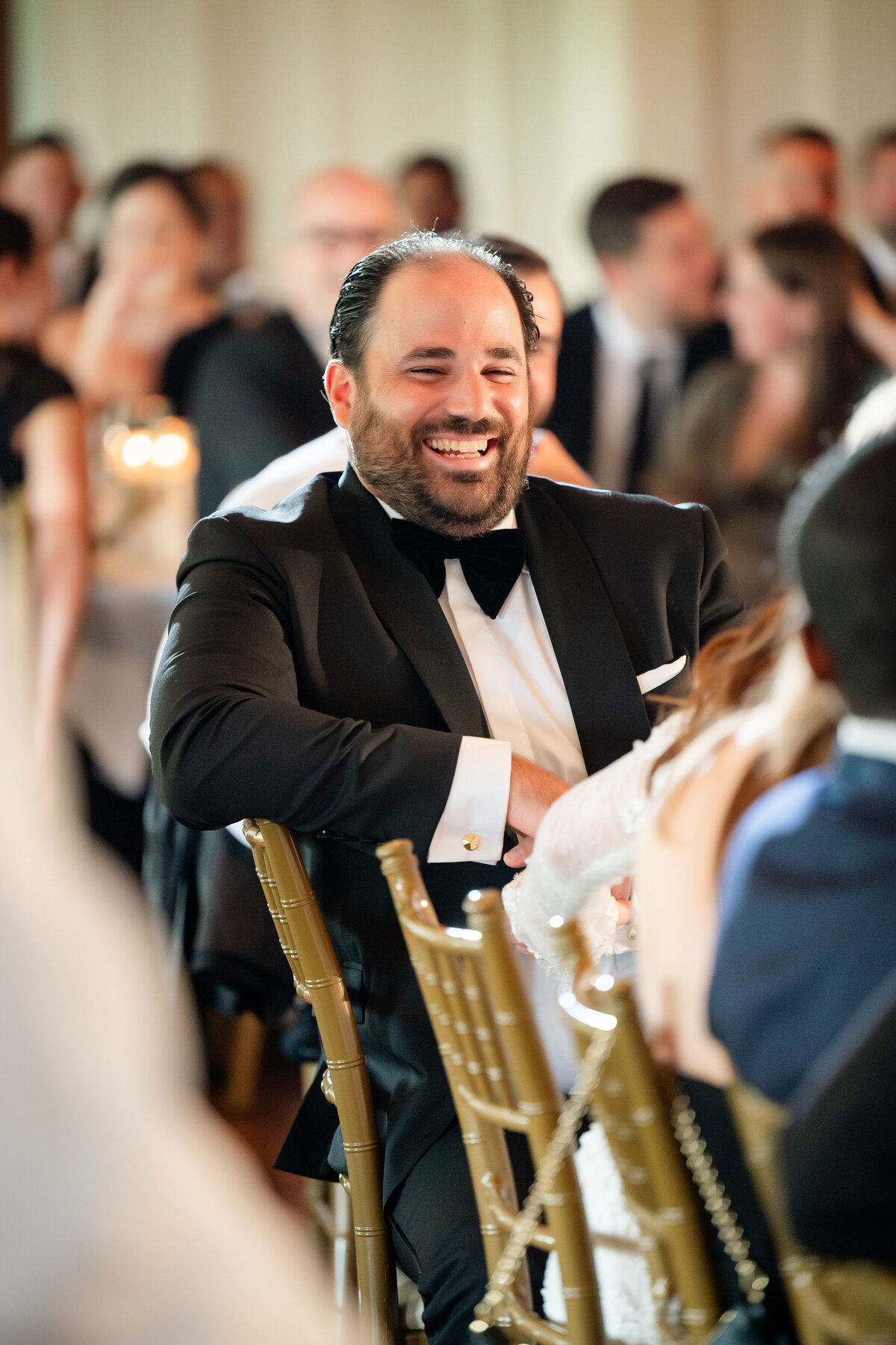 groom smiling during wedding speech