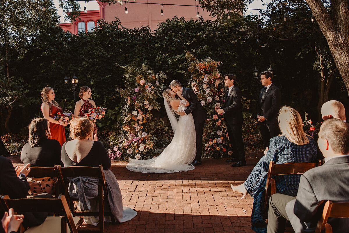 A couple during their first kiss at their wedding ceremony 