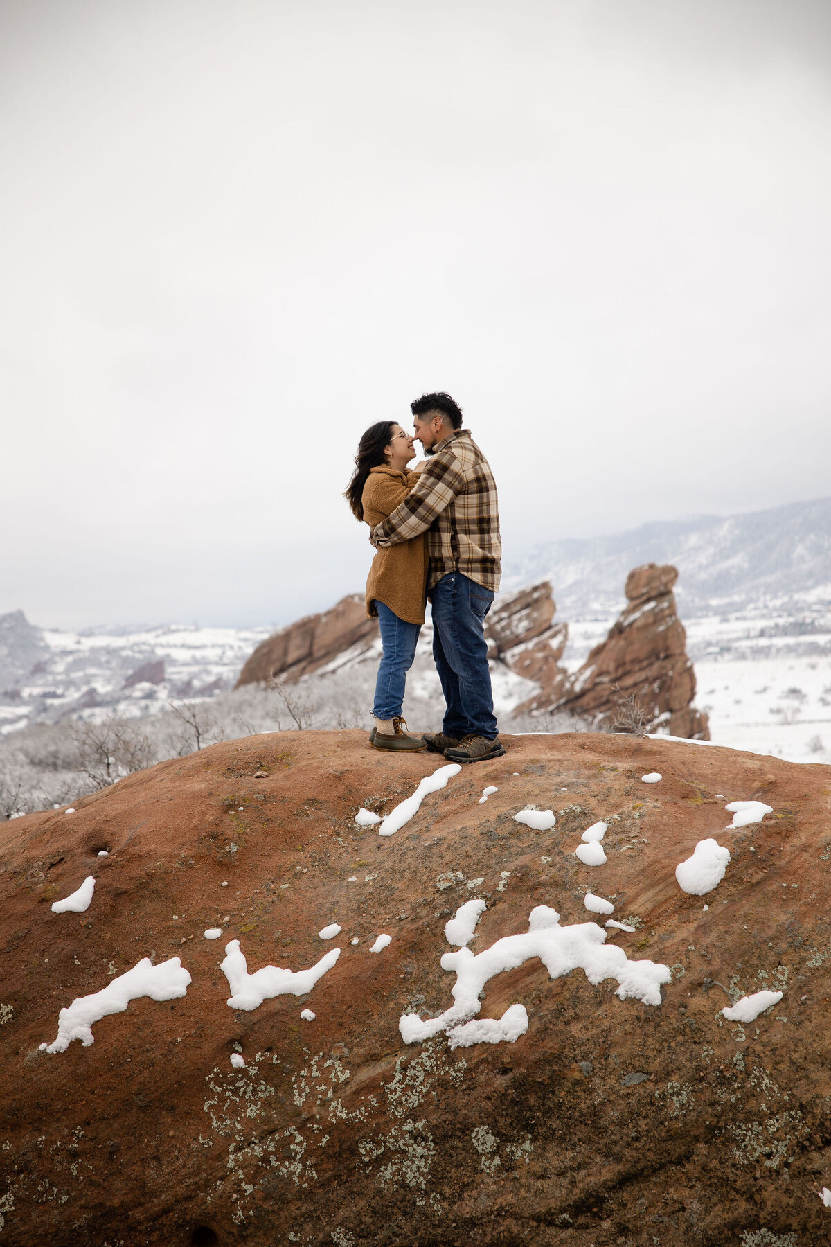 Romantic couple holds each other during a snowy  Denver photoshoot