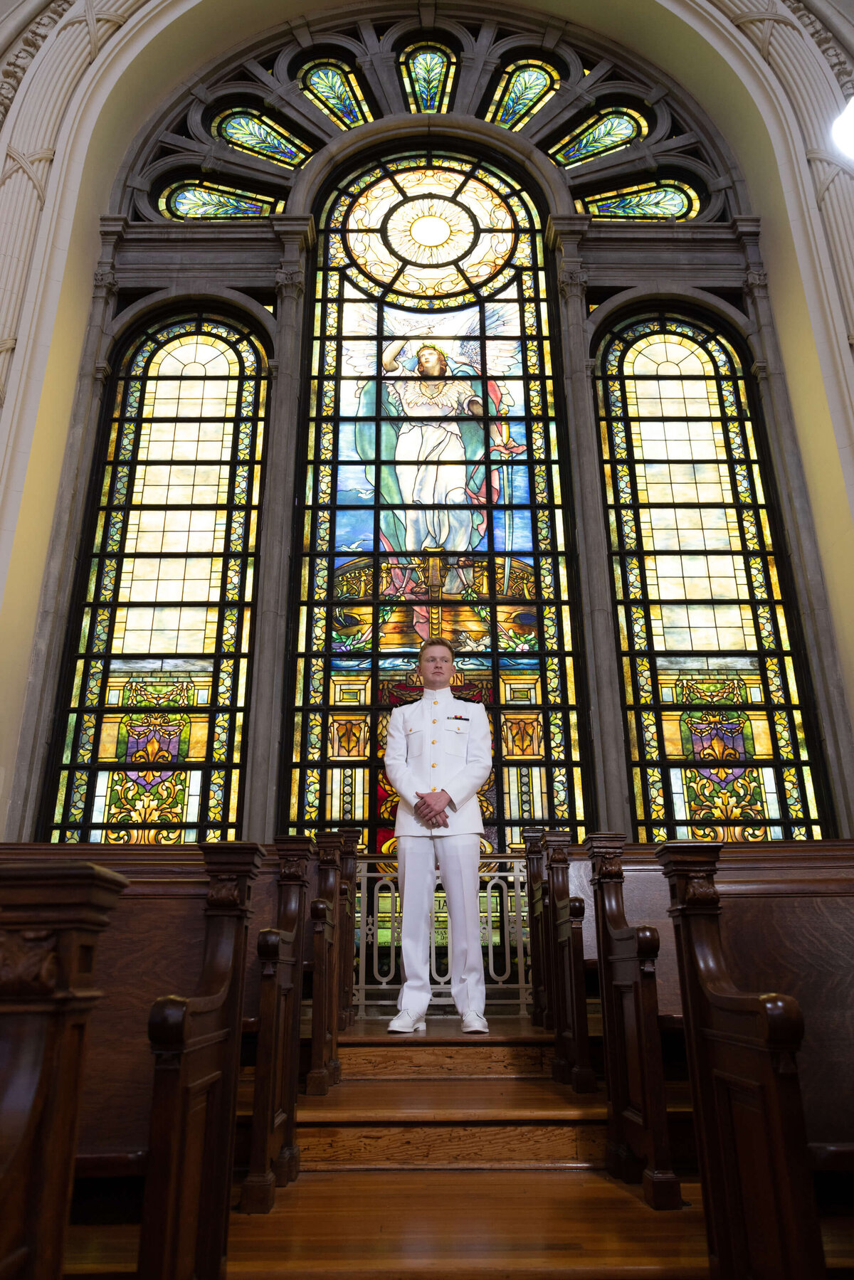 USNA Midshipman senior portrait with stained glass at the Naval Academy Chapel in Annapolis Maryland.