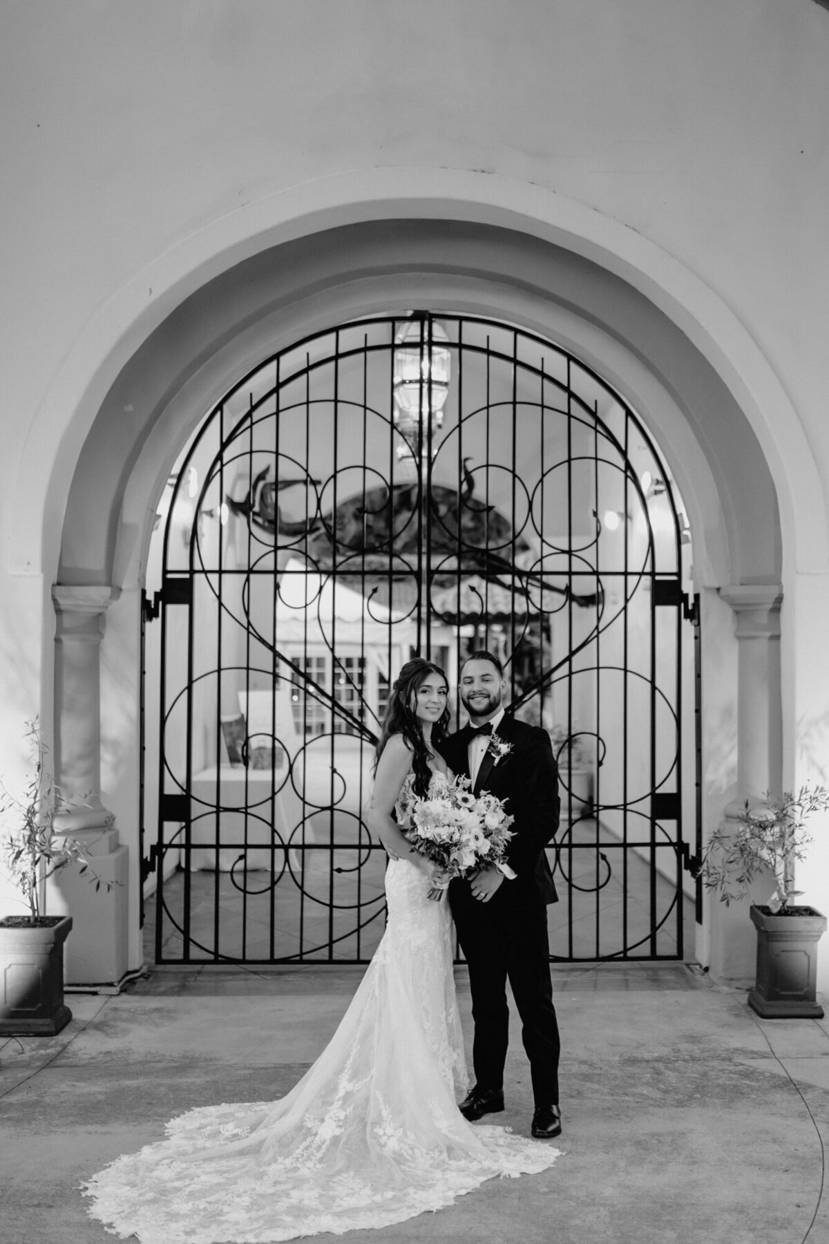 Laguna Beach bride and Groom standing in front of their event venue in black and white.