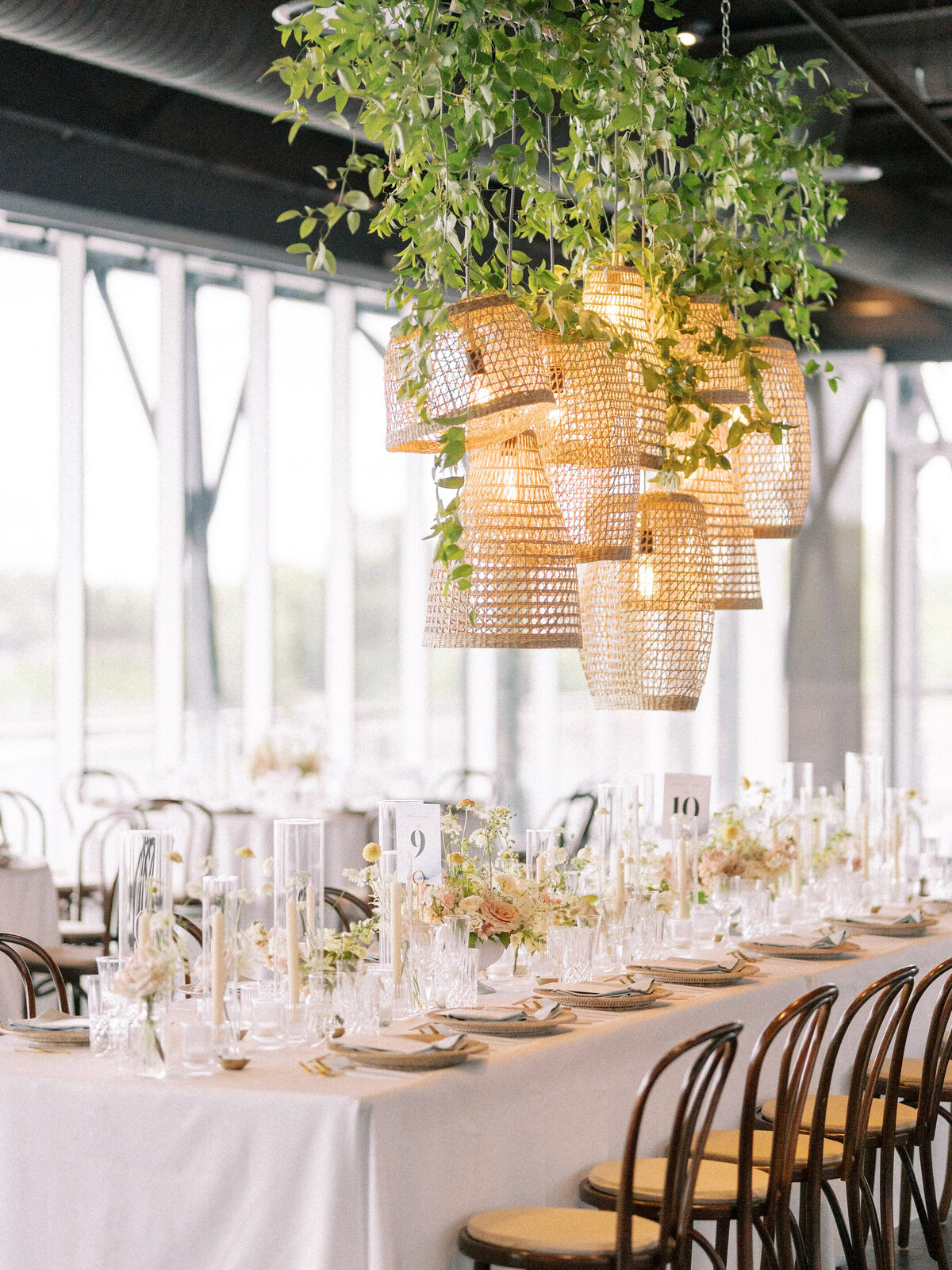 Lush suspended greenery on bamboo light fixtures at a wedding reception at the Science Centre.