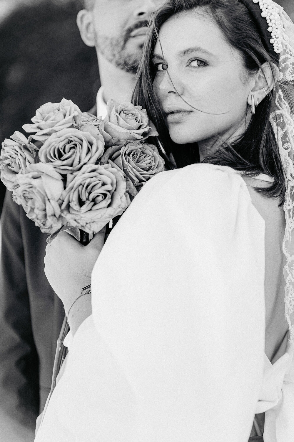 Genieße den zauberhaften Moment, in dem die Braut mit ihrem eleganten weißen Rosenstrauß und der Bräutigam in liebevoller Nähe am idyllischen Schloss Benrath verweilen. Tauche ein in die Romantik und Eleganz dieser feinen Kunst-Hochzeitsfotografie.