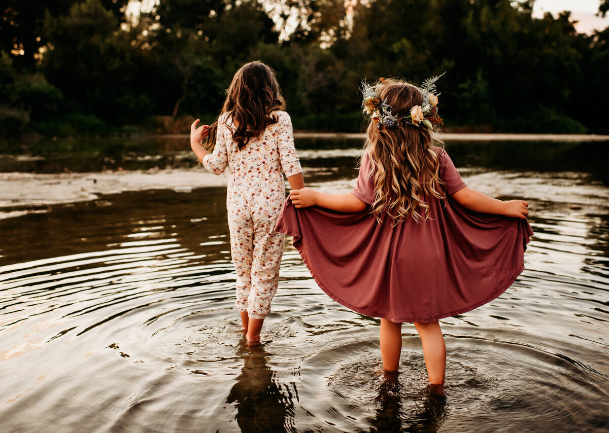 Little girls walking in the creek.