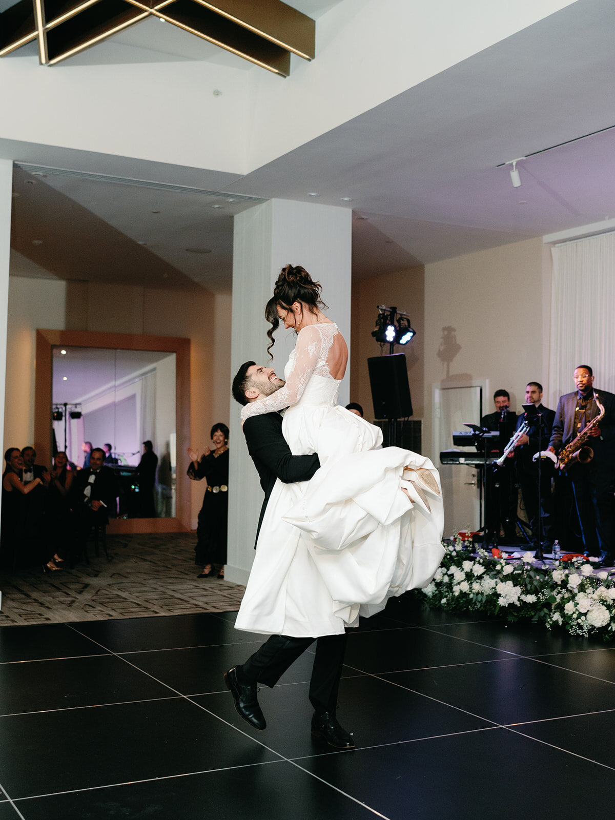 Groom lifts bride at their first dance at wedding reception at Hotel Washington grand ballroom 