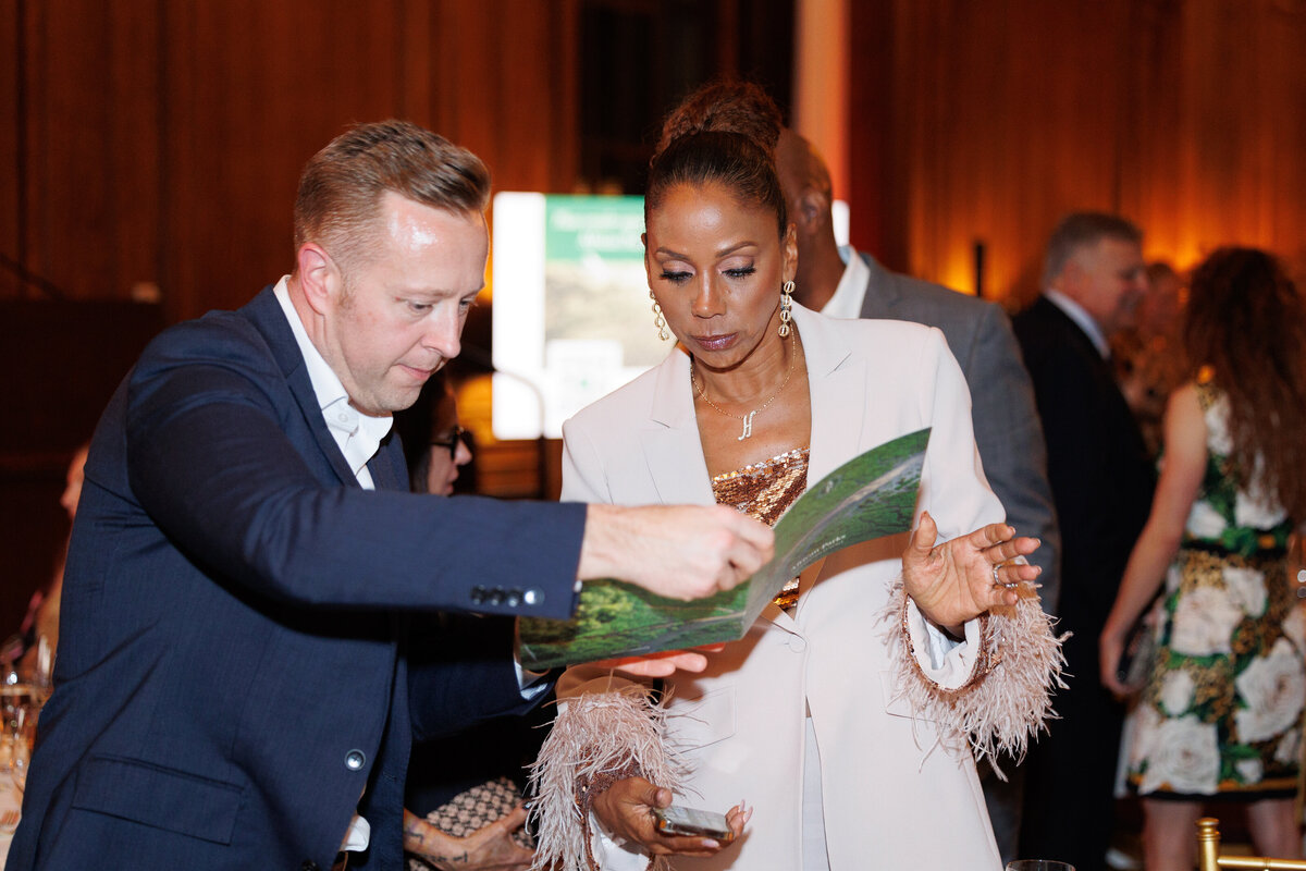 Holly Peete looking at a brochure