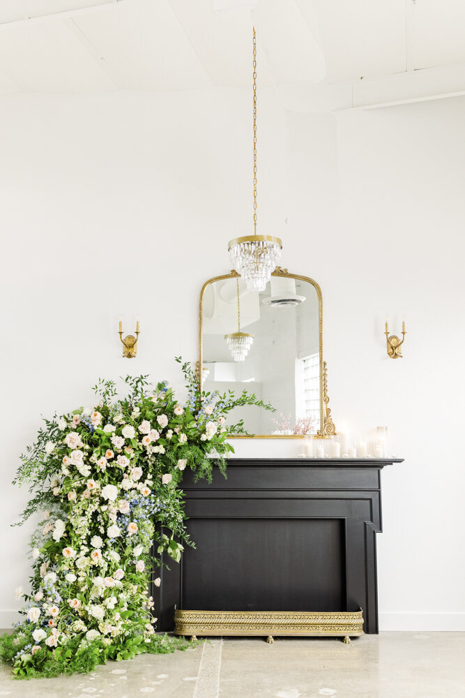 a dresser with a floral arrangement beside it