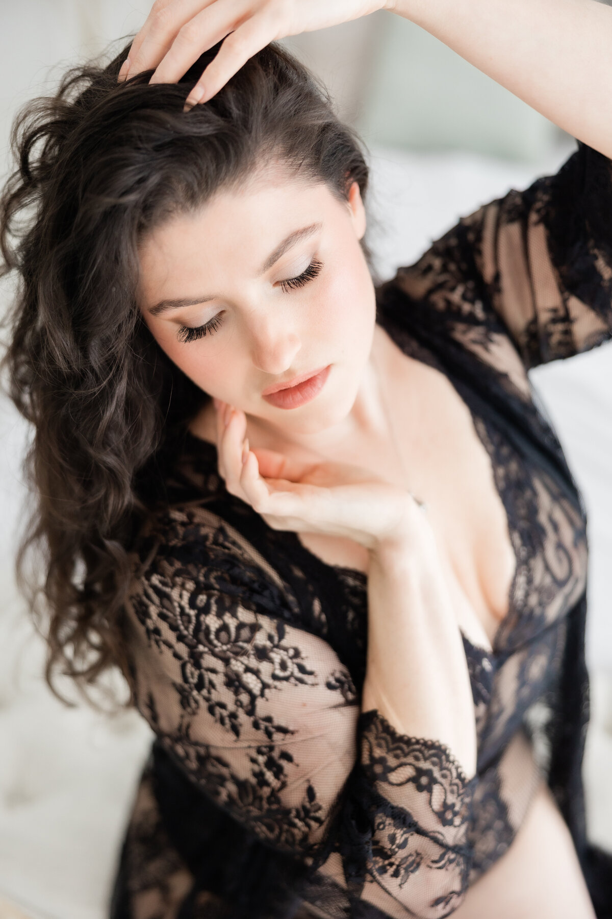 A closeup of a woman in a black lace outfit in a boudoir shoot at the Brand Studio Orlando