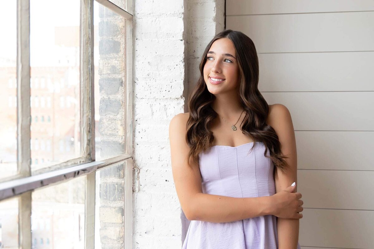 pastel-senior-girl-looking-out-window
