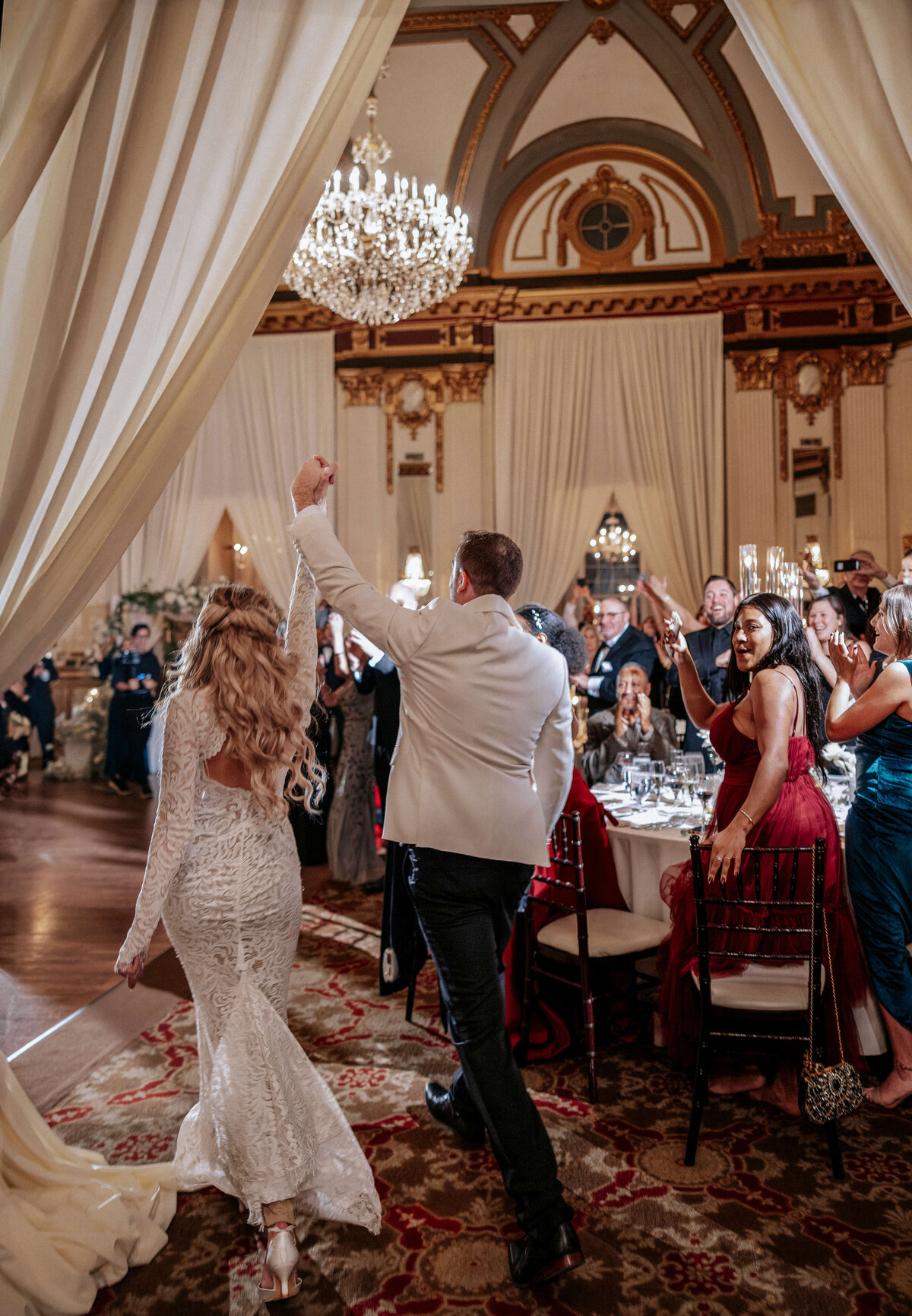 newlyweds-entering-reception-to-cheers