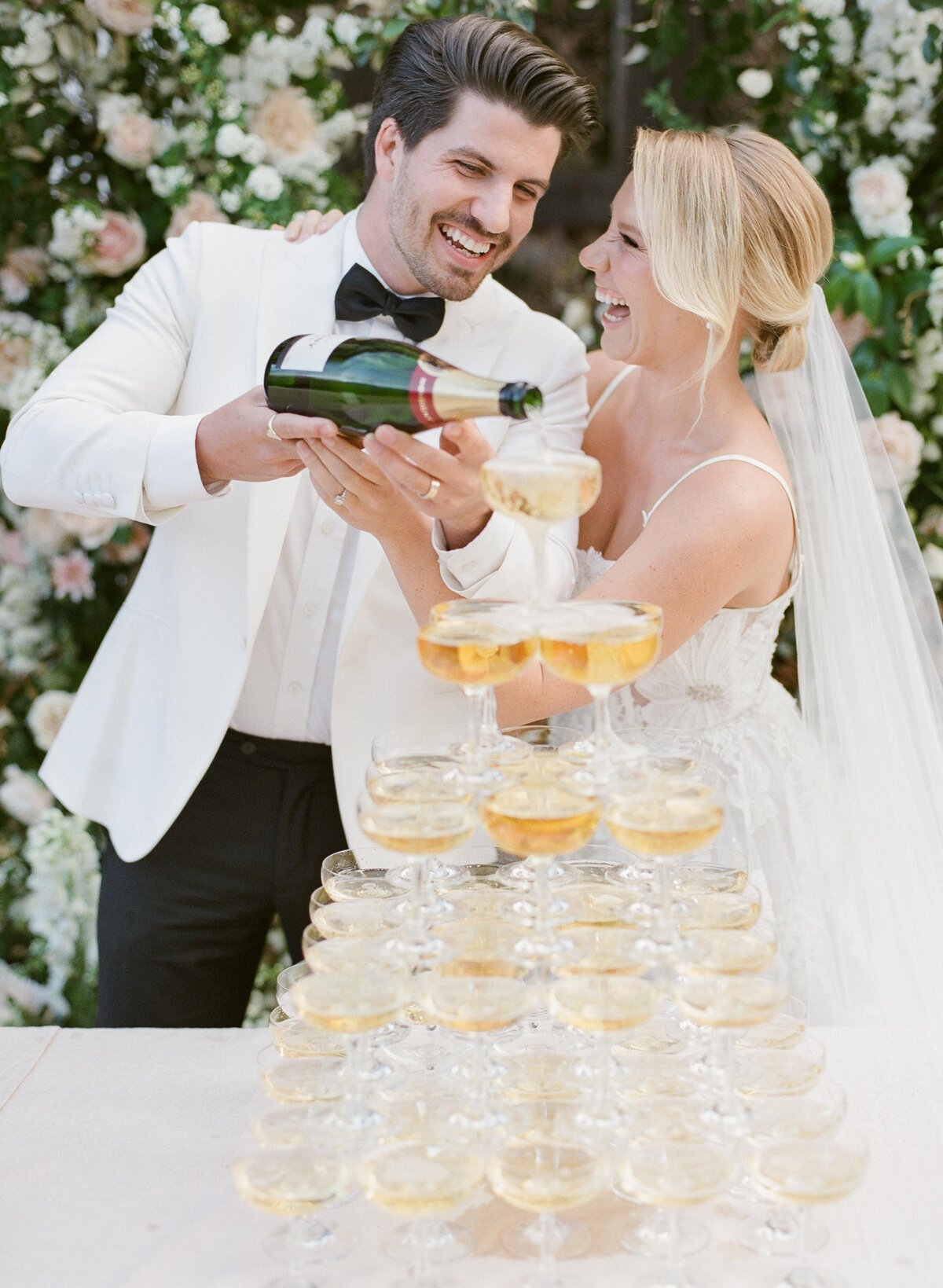 wedding couple pouring champagne