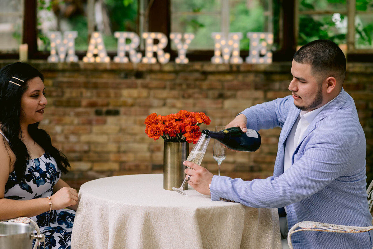 Perfect proposal location in Austin man pouring glass of champagne