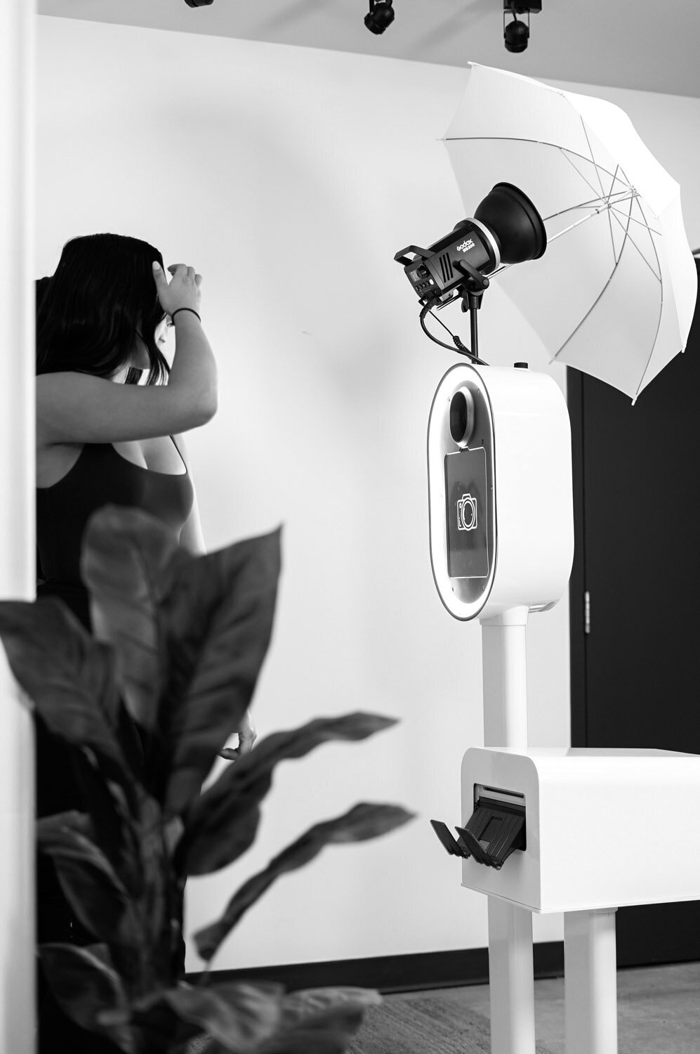 Image of a white photo booth with a light on top and photo printer to the right
