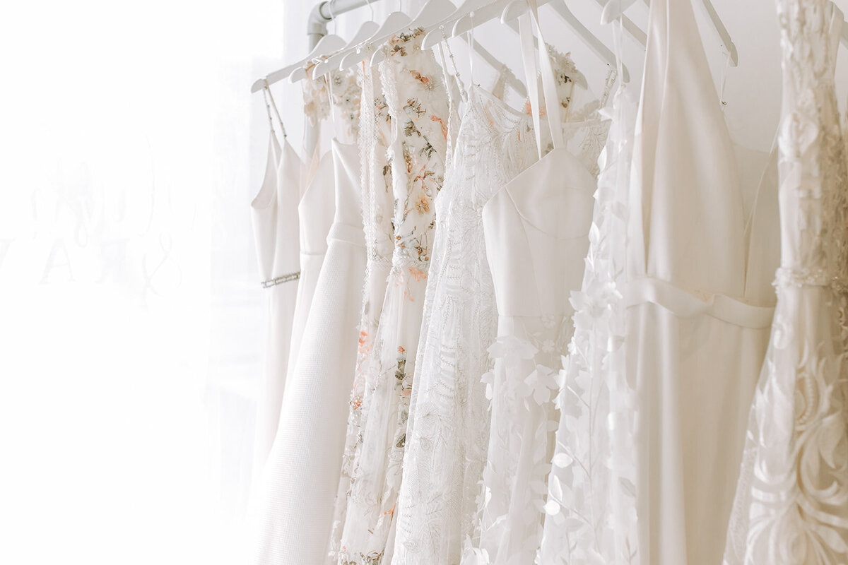Bridal gowns hanging at Blush & Raven, a couture wedding bridal boutique based in Calgary, Alberta. Featured on the Brontë Bride Vendor Guide.