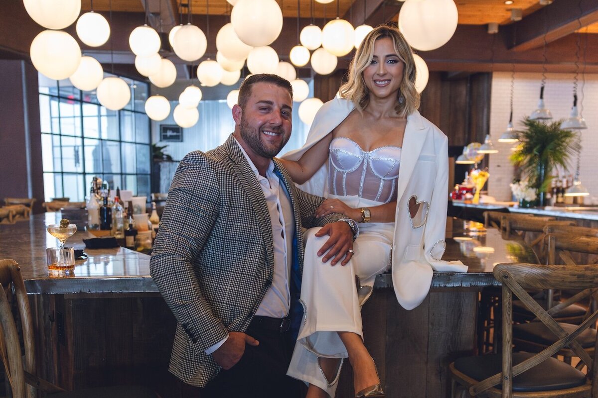 Couple laughing over drinks at Felina’s stylish bar area.
