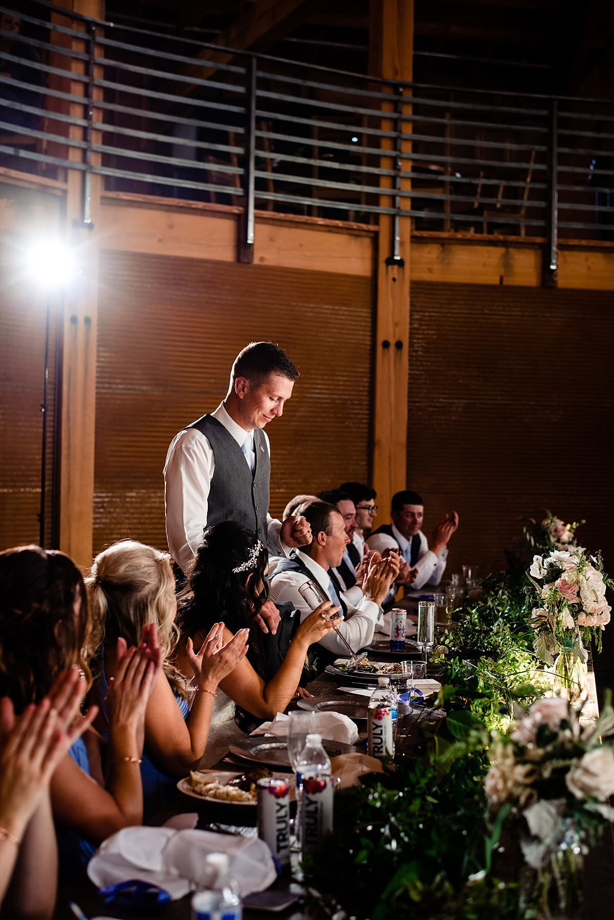 Groom standing at the head table and giving a welcome speech to his guests