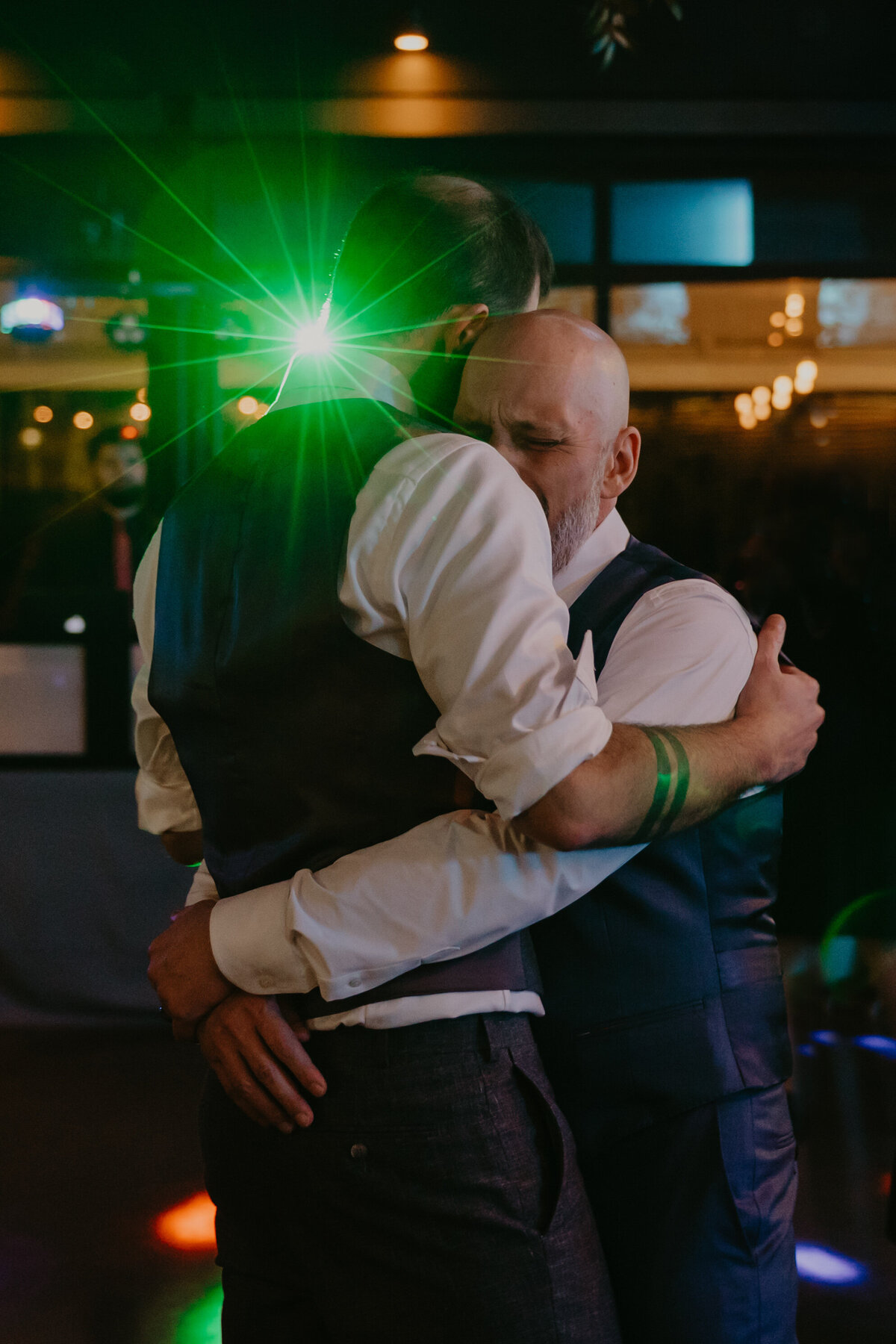 grooms dancing to their song at the end of their wedding