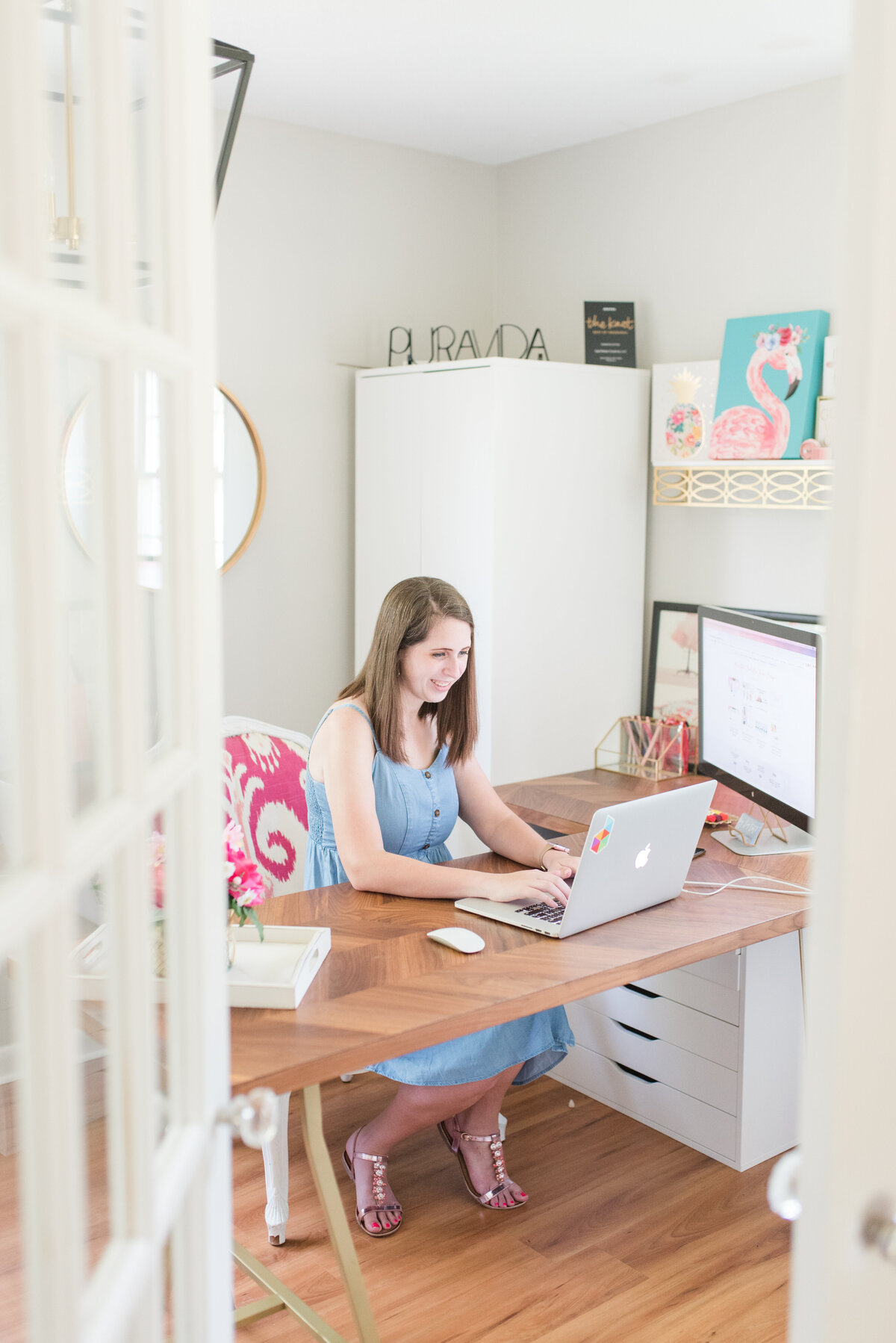 Cait Potter working on a laptop at her desk
