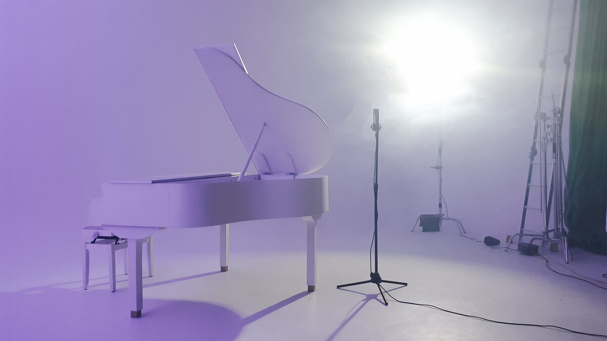 white baby grand piano hire for studio video shoot