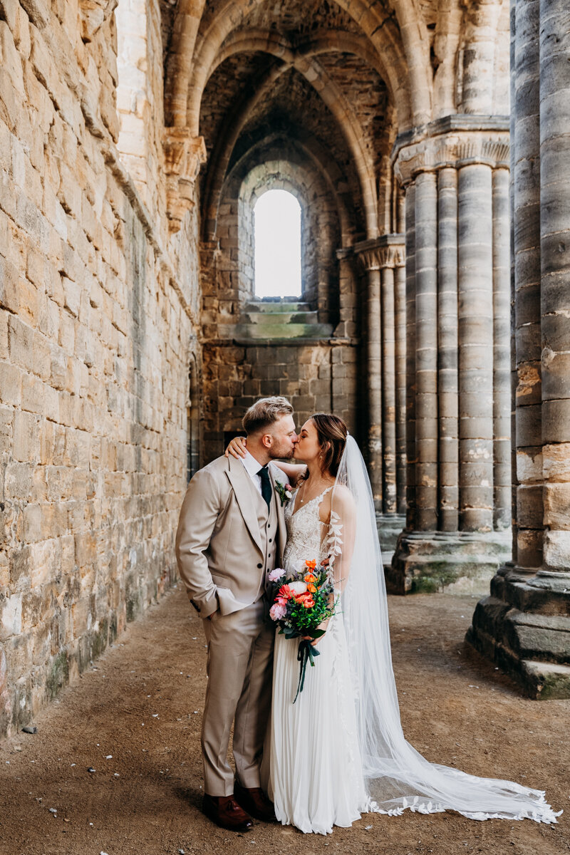 Bride and Groom kissing at Kirkstall Abbey wedding