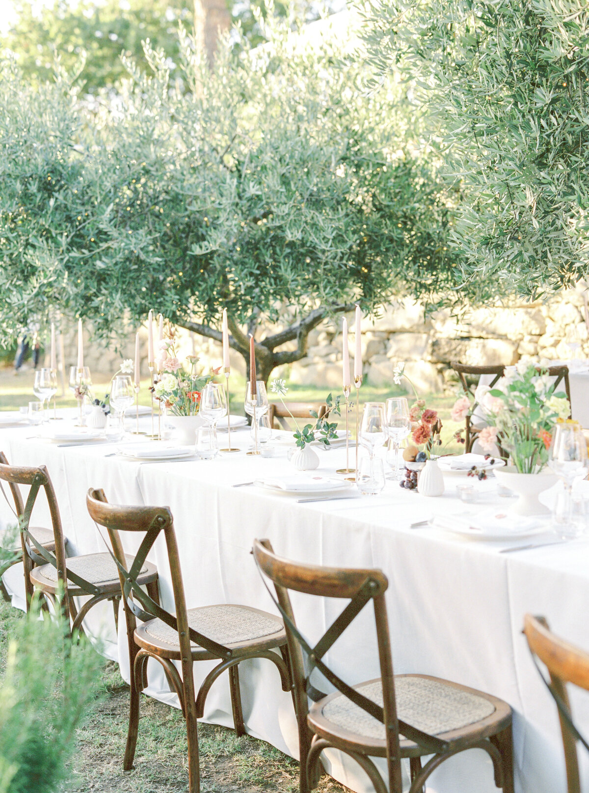 Film photograph of wedding reception tables among olive trees in tuscany photographed by Italy wedding photographer at Villa Montanare Tuscany wedding