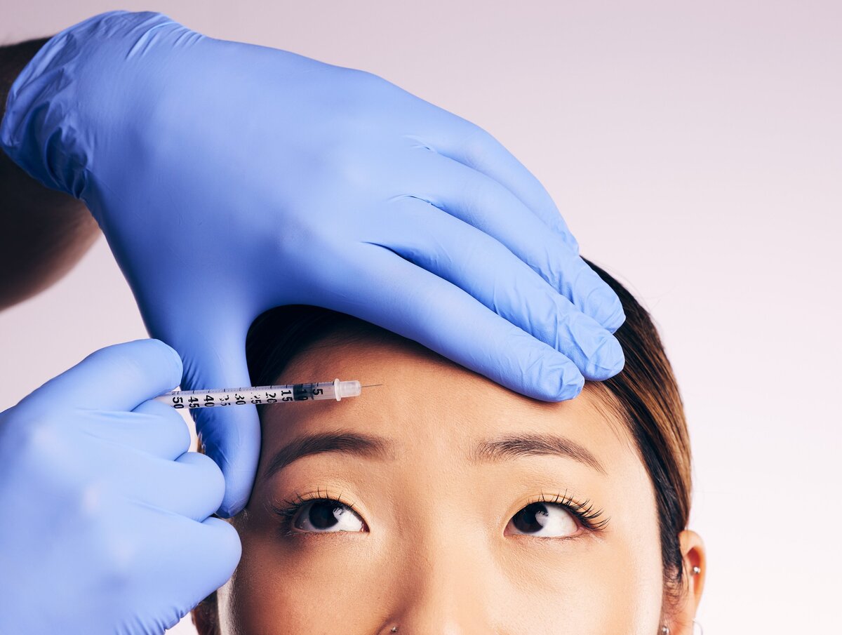 face-skincare-forehead-injection-and-asian-woman-2023-11-27-04-53-11-utc