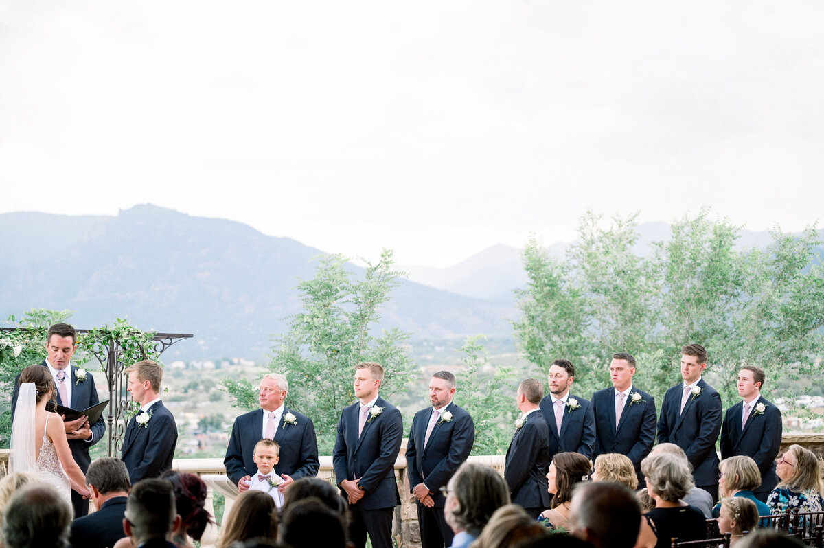 ceremony at the pinery while the bride and groom exchange vows with the mountains in the background