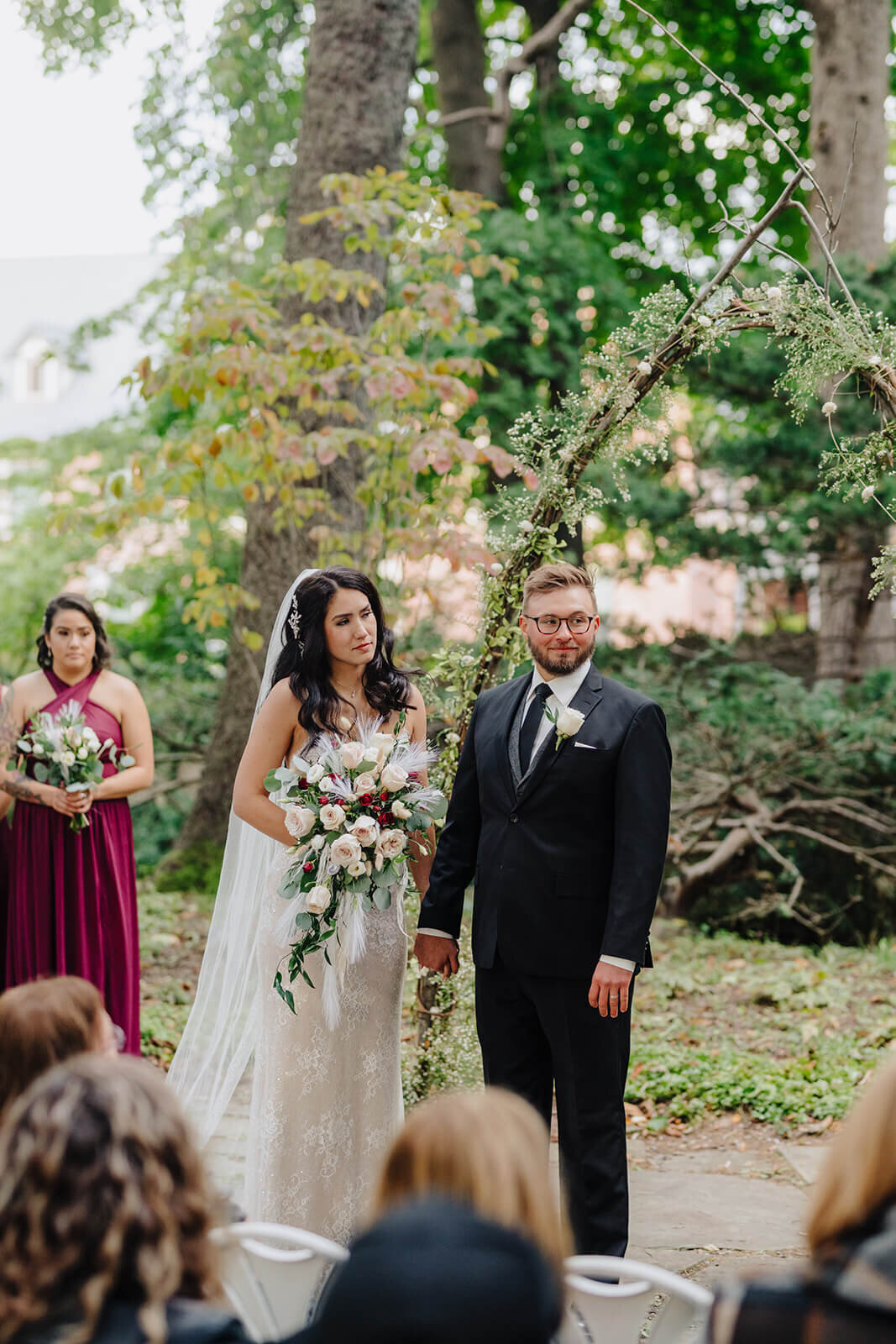 Bride and groom looking at guests at forest wedding, Finger Lakes, NY