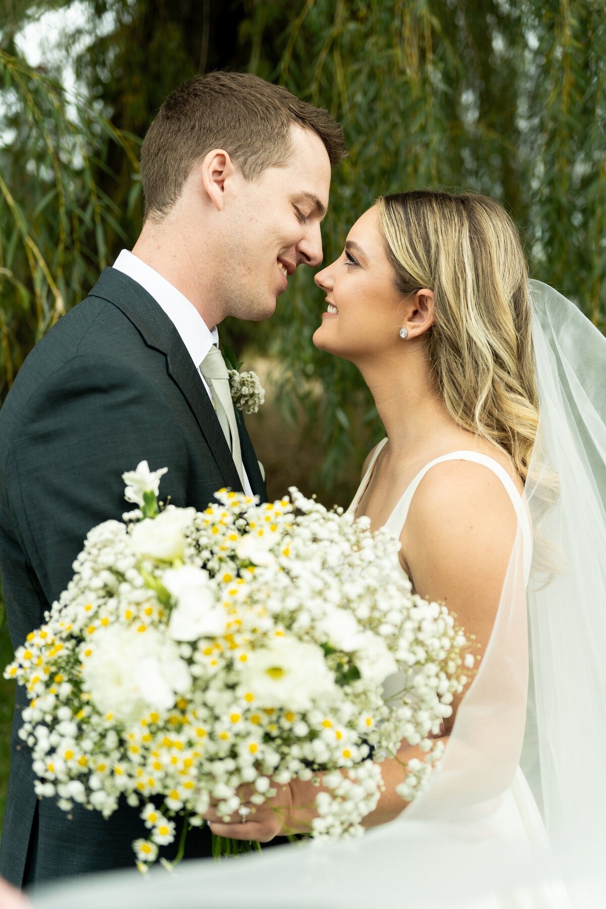 romantic veil photo of bride and groom at outdoor wedding White Birch Barn