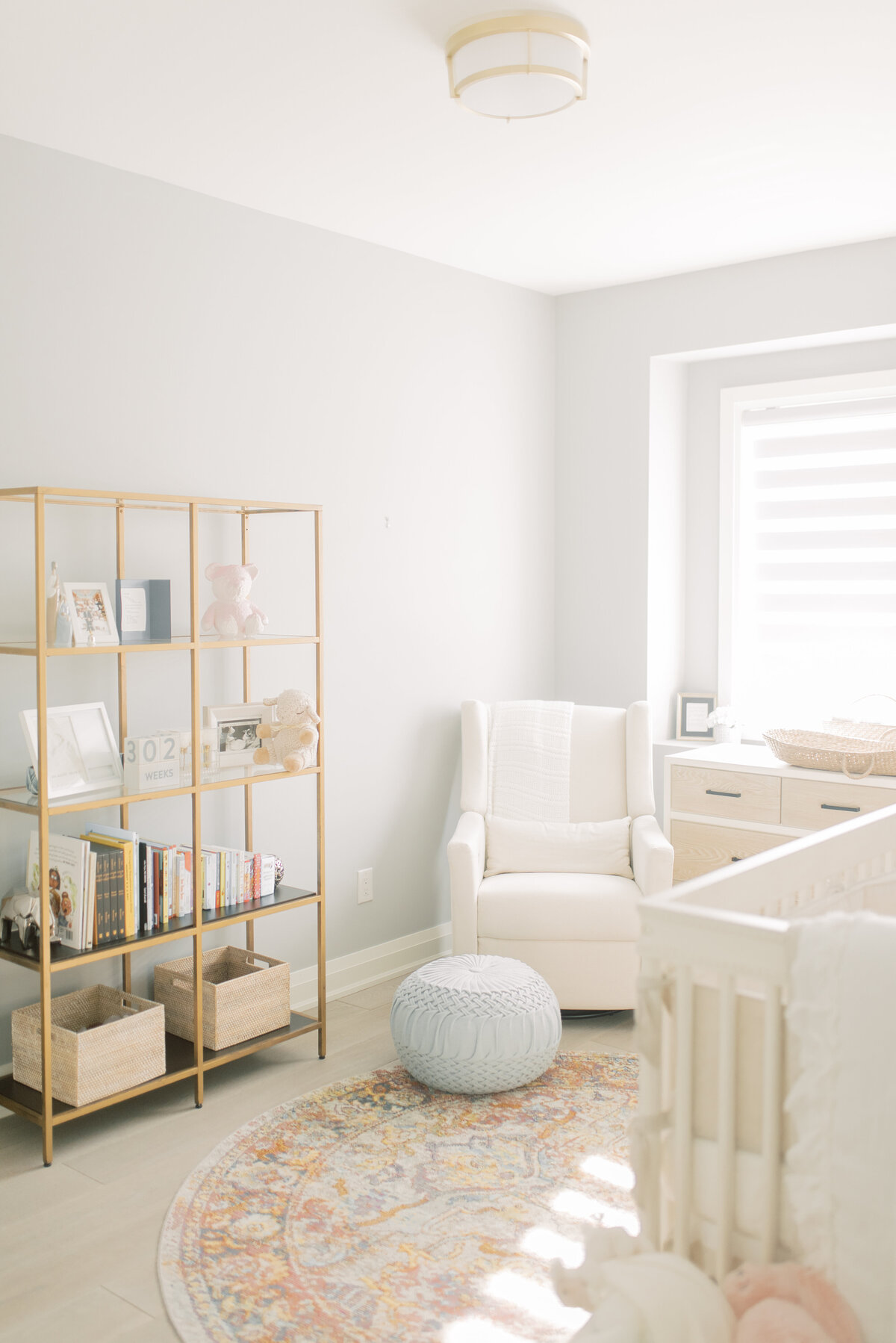 Bright and cozy nursery filled with soft light, books, and woven textures – styled Vaughan home session