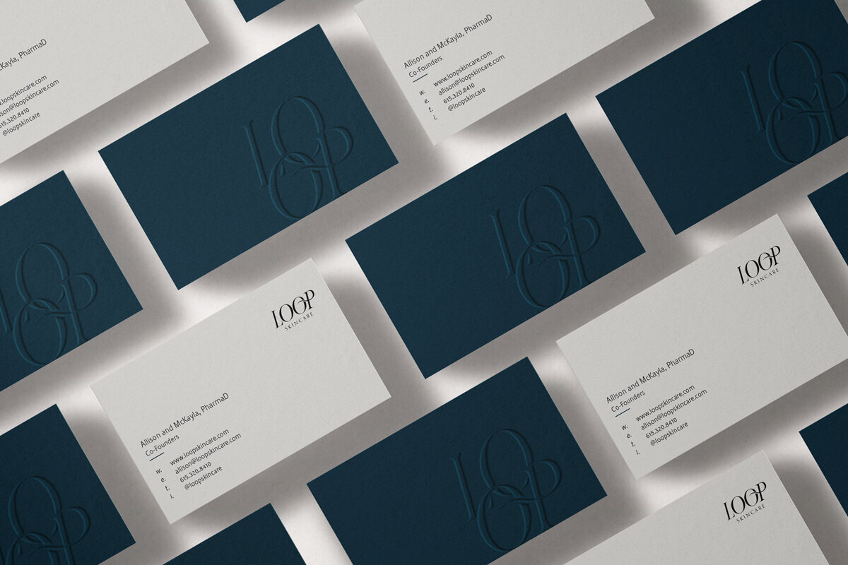 A mockup of business cards for Loop Skincare