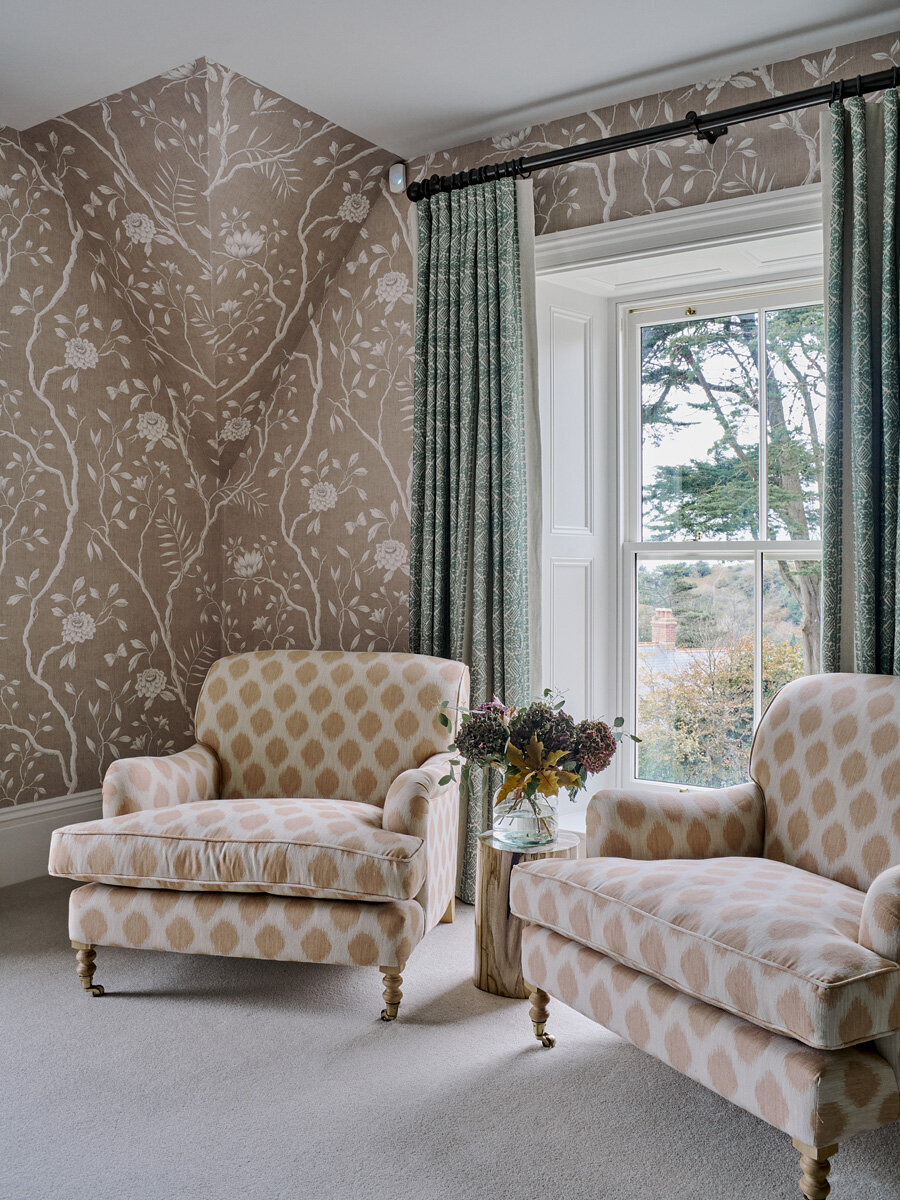 dual bespoke armchairs and flower arrangement 