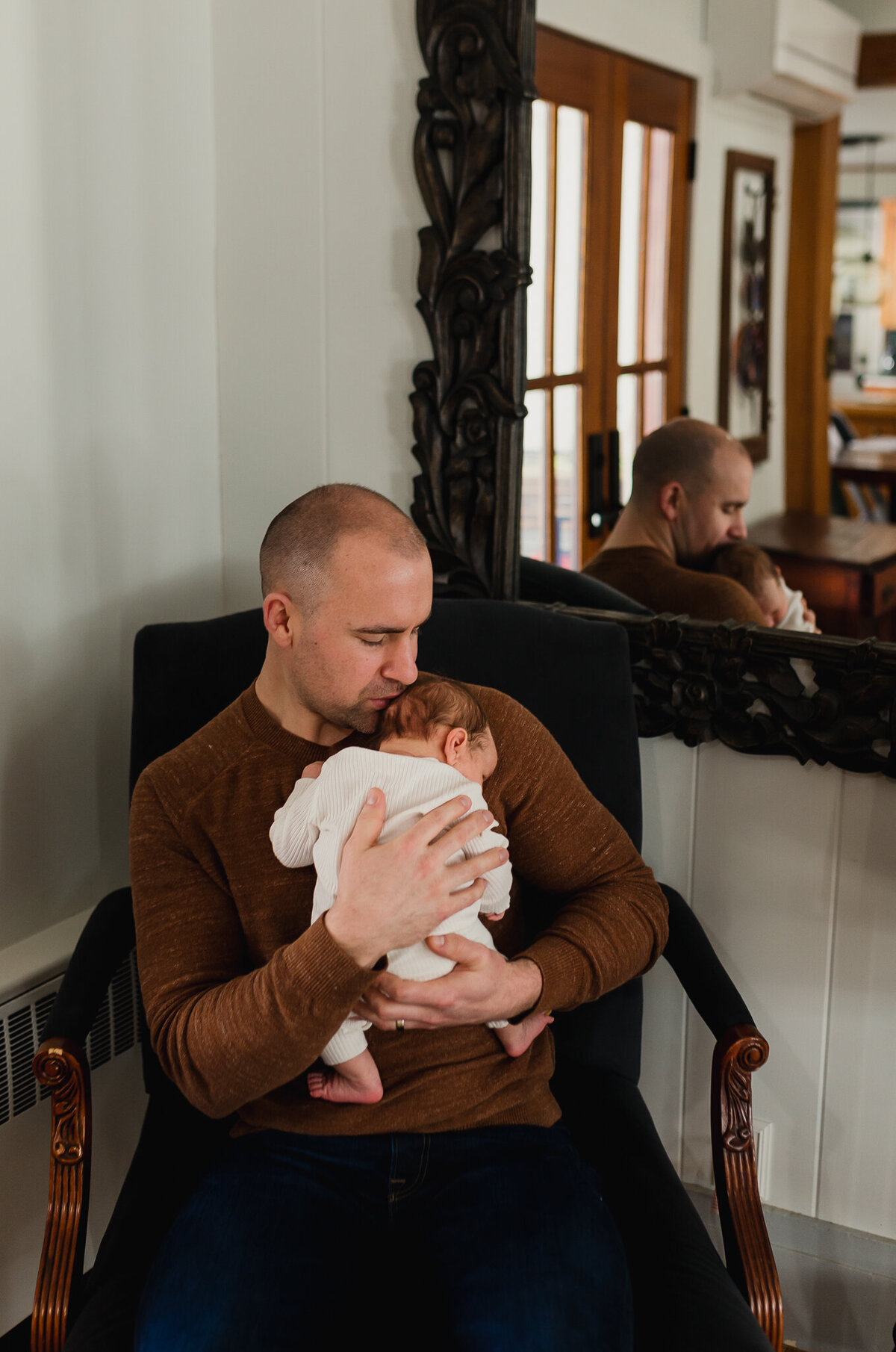 Family Photoshoot Session with dad holding newborn baby.