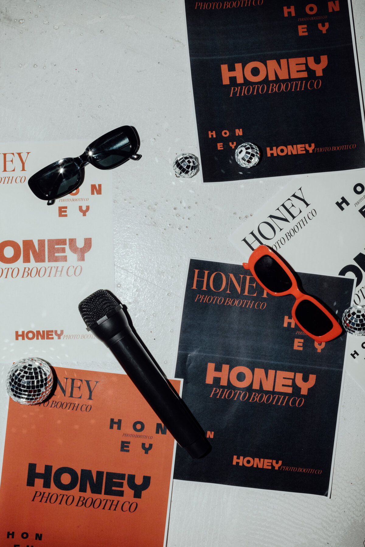 Girl with brown hair and burnt orange button down smiling with a hand on her hip, owner of Honey Photo Booth Co