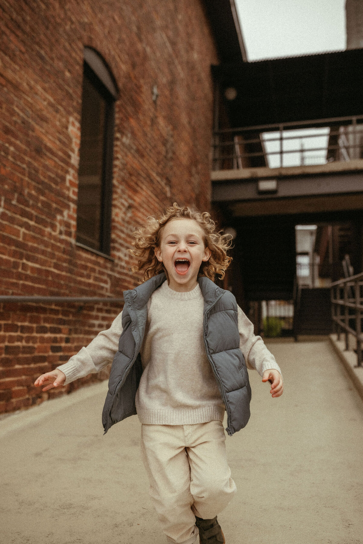 A young boy running and laughing in downtown Marietta, GA. 