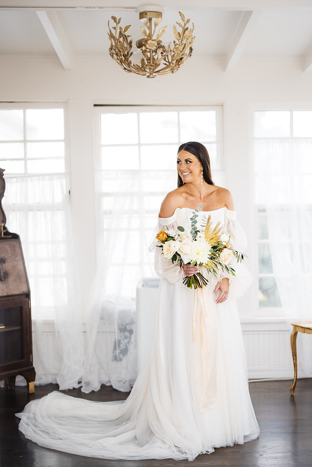 Bride poses with her boho wedding bouquet.