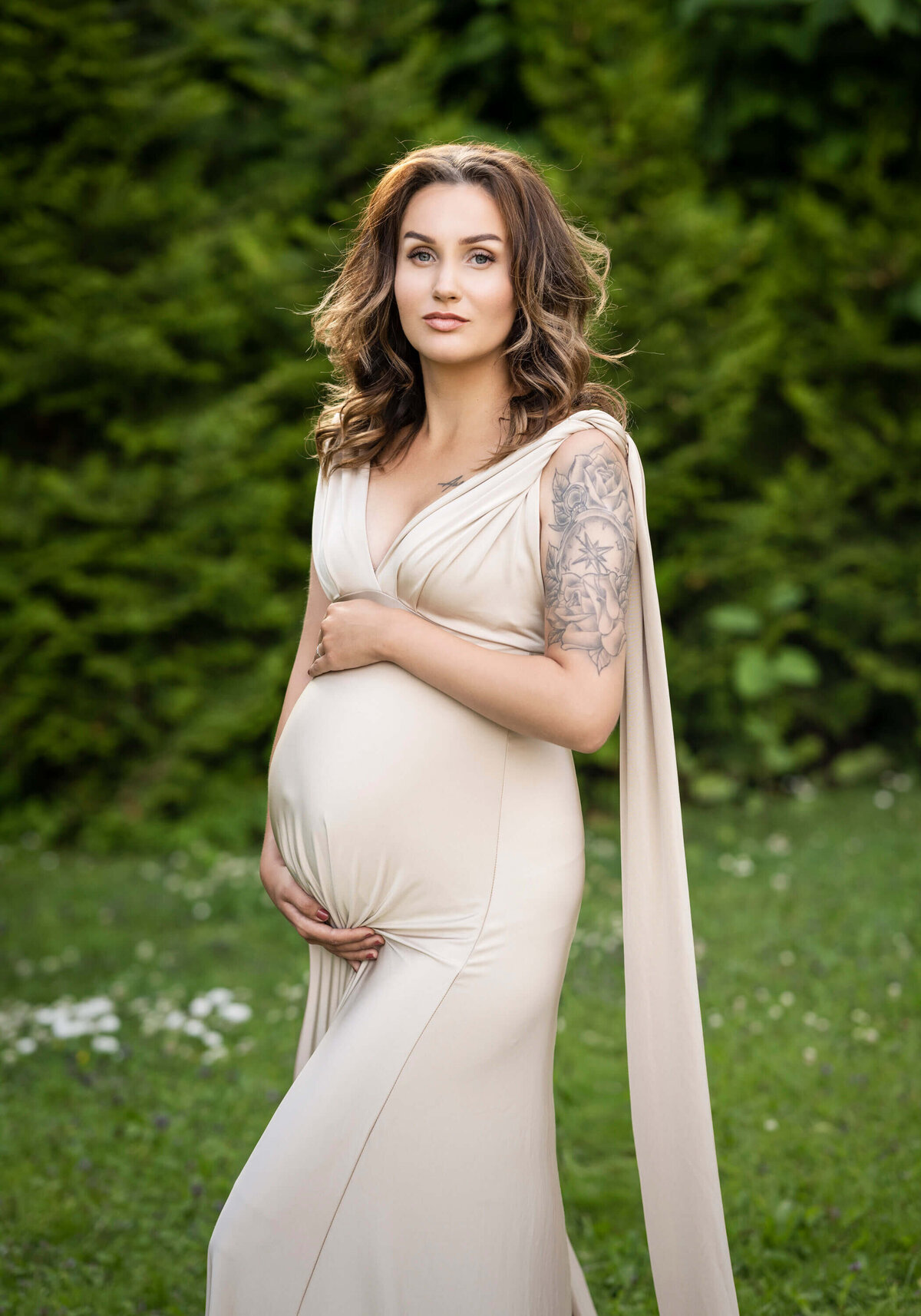 Radiant maternity portrait in soft outdoor light.