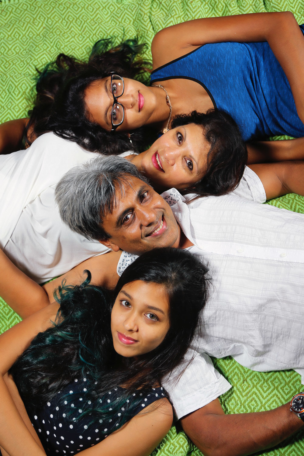 Family portrait of mom, dad, and two daughters. Photo by Ross Photography, Trinidad, W.I..