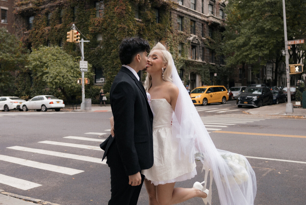 Elopement couple sharing a romantic moment in front of a brick building in NYC.