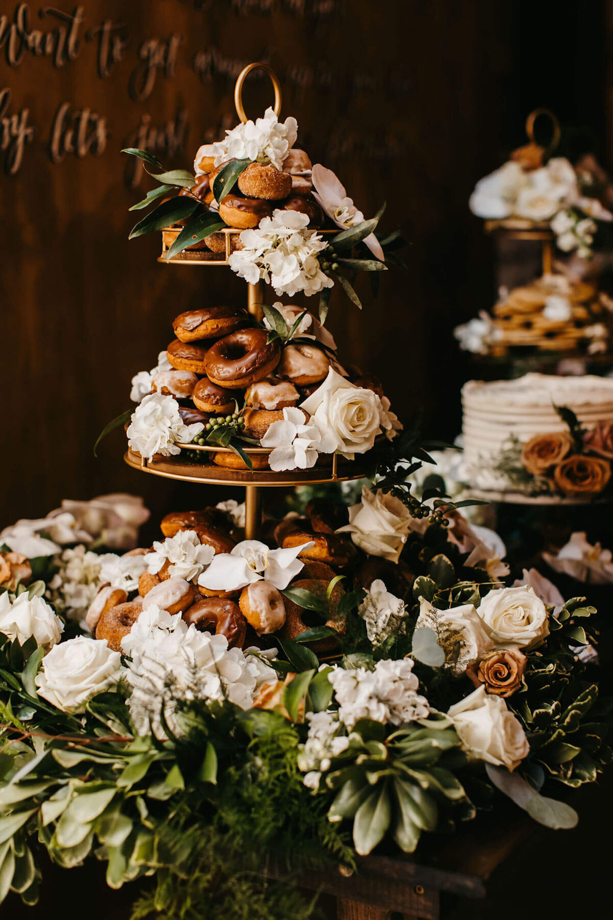 Doughnut dessert display with wedding cakes